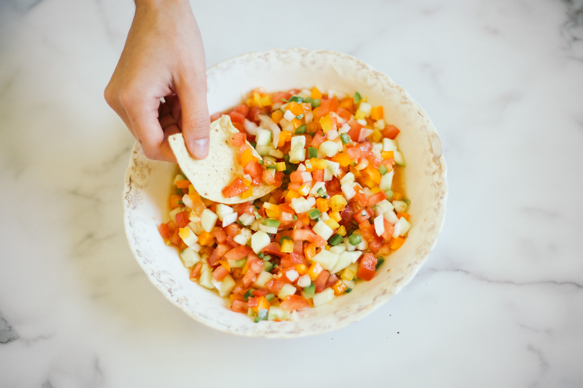 scooping fresh mediterranean salsa with chip miss northerner